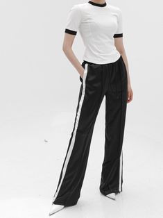 Midweight satin track trouser pants with side stripe in contract color. Straight leg with slight flare at bottom. Model is in MINUSEY S. ✔️ Free worldwide express shipping over $100✔️ Loved by 6,500+ customers✔️ Limited edition collections, maximum style⠀⠀⠀⠀⠀⠀⠀⠀⠀Stay ahead of the trend with can’t-find-anywhere-else staples. Your closet will thank you 💕* MINUSEY S = EU 34, US 2* MINUSEY M = EU 36, US 4* 100% Polyester* Dry clean* Made in Korea - Model Height: 172cm/5'7" (US2, EU34) Pants With Side Stripe, Waiting List, Side Stripe, The Trend, Trouser Pants, Cotton Tops, Sleeve Cotton, Half Sleeves, Contrasting Colors