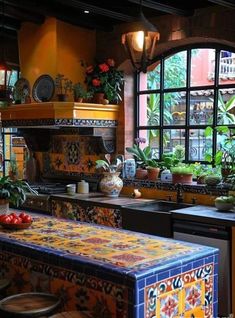 a kitchen with many potted plants in the window sill and an island counter