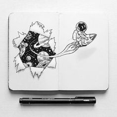 an open notebook with space drawings on it