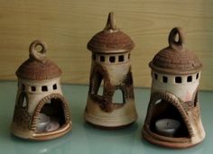 three ceramic objects sitting on top of a table