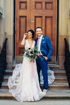 a bride and groom pose for a photo in front of a door