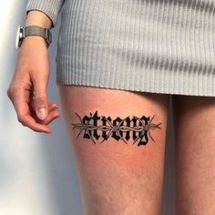 a woman's thigh with the word tattoo on it