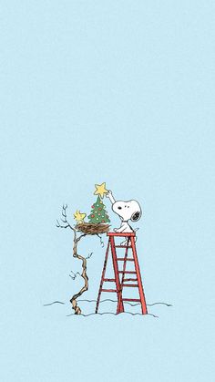 a snoopy christmas tree sitting on top of a ladder next to a small star