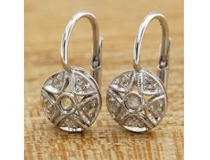 -Lovely dangle earrings made of 14k white gold, circular shaped frame characterized by a star shaped perforated motif, embellished with rose cut diamonds, finely set. Sturdy and practical leverback closure. -Refined and exclusive, these earrings can be a wonderful gift for a special occasion. -Entirely handmade jewel, regularly marked with the gold title (585) and of the Italian manufacturer. -CHARACTERISTICS 14k (585) white gold and 0.16 ctw natural diamonds. Weight: 3.2 grams. Height: 1.7 cm (0.67 inch). Diameter: 0.95 cm (0.37 inch). -The earrings are shipped complete with elegant packaging and warranty. -Any taxes and customs fees are not included in the item price or shipping cost. These charges are the buyer's responsability. -IMPORTANT This product is created entirely by hand by our White Gold Pierced Diamond Earrings, Pierced White Gold Round Diamond Earrings, White Gold Round Diamond Earrings, Round White Gold Diamond Earrings, Sterling Silver Diamond Earrings With Lever Back, Fine Jewelry Round Diamond Earrings With Ear Wire, Wedding Diamond Earrings With Ear Wire, Round White Diamond Earrings With Lever Back, Round Diamond White Diamond Earrings With Lever Back