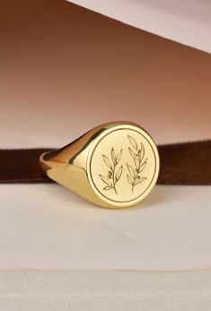 Welcome to LUXJ, Here you will find a beautiful selection of round signet rings with a variety of designs such as our Olive Branch signet ring. Our team is happy to assist you with any questions you may have and we look forward to creating these special jewelry for you. *The images are taken from us and you will receive your ring as shown* | Information about the ring | - Face Size: 14x14mm - Band width at the bottom: 4mm | Material | - Sterling Silver 925 - Gold Vermail (925 base) - 9K Real Gol Olive Branch Signet Ring, Olive Branch Jewelry, Branch Jewelry, Gold Pinky Ring, Signet Rings Women, The Ring Face, Signet Rings, Gold Signet Ring, Olive Leaf