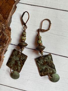 Copper patina charms by Peke Scott dangle from the most beautiful etched copper beads. Copper findings and ear wires. 2-1/2 inches long. Natural Earrings, Tin Jewelry, Recycled Tin, Etched Copper, Nature Earrings, Copper Patina, Green Earrings, Long Earrings, Clay Jewelry