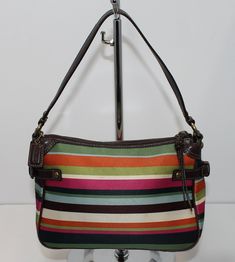 This colorful Coach tote bag measures approximately 6” x 10” x 4”. This is a used bag with minimal wear and minor staining on the front. Please closely inspect all photos before purchasing. Closure: Zip Strap Drop: 6” Color: Multi-Color Pockets: 1 Interior & 1 Exterior Material: Nylon Style: Tote Bag Photos are Actual pictures, not stock photos. Authenticity Note: We have been trained to spot fake designer bags, and closely inspect each purse to verify authenticity. If we have any doubts, we NEV Casual Multicolor Satchel For Errands, Casual Coach Rectangular Shoulder Bag, Casual Rectangular Coach Shoulder Bag, Casual Coach Satchel For Shopping, Multicolor Travel Shoulder Bag With Handle Drop, Multicolor Shoulder Bag With Top Carry Handle For Errands, Multicolor Satchel For Errands With Top Handle, Casual Coach Tote Satchel, Multicolor Coach Bag For Travel