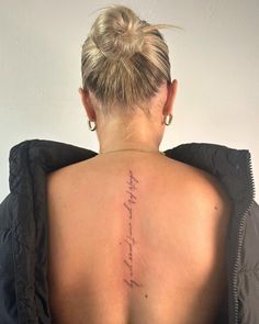 the back of a woman's neck with her handwriting on it