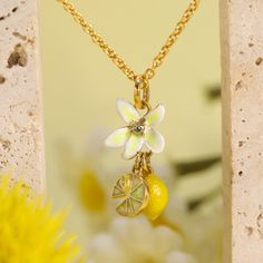 The Lemon Quartz Necklace dazzles with its citrusy charm, featuring a radiant gemstone that captures the essence of sunshine and brings a bright, joyful touch to any attire. The Lemon Flower Necklace is a radiant treasure, featuring a brilliant lemon quartz gem that exudes vibrancy. Encased in a sleek setting of silver with an 18K gold finish, this necklace is a burst of sunshine around your neck, perfect for brightening any day and adding a cheerful sparkle to your favorite outfits. DETAILS Plating: 18K Gold Materials: 18K Gold on Brass, Enamel, Cubic Zirconia, Pearl Measurements: Length: 16.14"(41cm) + Extender: 1.97"(5cm) Pendant Size: 1.89"*1.02"(4.8cm*2.6cm) Weight: 9.2g Elegant Yellow Charm Necklace For Gift, Elegant Yellow Charm Necklaces For Gifts, Enamel Necklaces With Flower Charm And Pendant, Gold Pendant Necklace Jewellery, Adjustable Yellow Flower Charm Necklace, Enamel Flower Charm Pendant Necklace, Lemon Necklace, Yellow Enamel Flower Shaped Jewelry, Lemon Flower