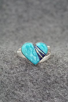 This turquoise, onyx, opalite and sterling silver inlay ring was made by Navajo silversmith Michelle Willie. The inside of the band is signed and stamped .925.Size: 8 adjustableLength: 1/2"Width: 5/8"Free shipping on all orders! We ship with USPS and always include tracking. All orders ship within a day of payment.Returns are accepted up to 30 days after you receive your order. Just send us a message. Our shop offers cash back or store credit. The item must be returned in the same condition. Silver Opal Ring With Inlay For Anniversary, Anniversary Silver Opal Ring With Inlay, Blue Opal Inlay Ring For Anniversary, Adjustable Turquoise Ring With Inlay For Gift, Blue Opal Ring With Inlay For Anniversary, Anniversary Blue Opal Ring With Inlay, Sterling Silver Inlay Ring, Opal Inlay Ring Gift, Turquoise Opal Rings As Gift