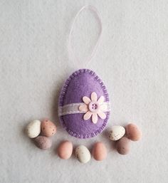 an egg with a flower on it surrounded by small eggs