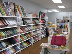 a room filled with lots of different types of fabrics on shelves next to each other