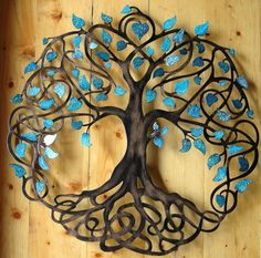 a metal tree with blue leaves on it