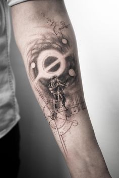 a man's arm with a clock and an eye tattoo on the left forearm