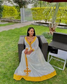 A stunning Habesha dress that features vibrant yellow tilf fabric and intricate shemena and tilf designs. Handmade by skilled artisans, this dress is a true work of art that captures the essence of Ethiopian fashion. Crafted from a luxurious cotton, the "Radiant Sun" dress is soft to the touch and drapes beautifully on the body. The full-length silhouette flatters all body types, while the shemena and tilf designs add an elegant touch to the overall look. The dress is perfect for formal occasion Ethiopian Fashion, Ethiopian Wedding, Habesha Dress, Ethiopian Jewelry, Ethiopian Traditional Dress, Ethiopian Dress, Religious Ceremony, Jewelry And Accessories, Sun Dress