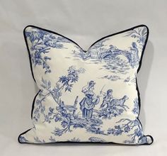 a blue and white pillow with an image of people on horseback in the background,