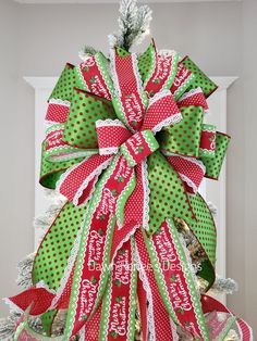 It's big and it's beautiful! Created in the traditional Christmas colors of green, red and white, this bow is going to take your Christmas tree to wow! Hand made in 3 different ribbons, including a premium ribbon in green and red polka dot, a red and white polka dot with lace edges and a Merry Christmas print in red, white and green. The long streamers will add to your tree's charm.If you'd like your tree topper to be 360 degrees, then please purchase 2 and put them back to back on your tree.Bow Polka Dot Christmas Tree, Dot Christmas Tree, Polka Dot Christmas, Lace Edges, Christmas Tree Bows, Christmas Print, Traditional Christmas, Red Polka Dot, Tree Topper