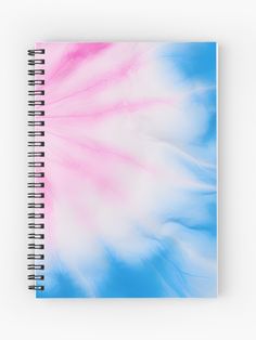 a spiral notebook with pink and blue swirls