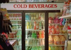 a cold beverage cooler in a store filled with drinks