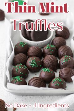 chocolate truffles with green sprinkles in a white tray on a table