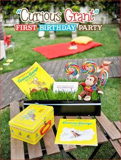 an outdoor birthday party with candy, books and candies on a picnic table in the grass