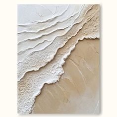 an abstract painting with white paint on the wall and beige sand in the foreground