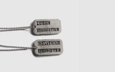 two dog tags with words on them hanging from chains