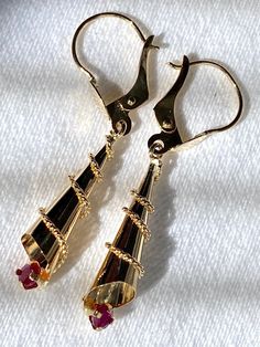 18k solid real gold and genuine Rby earrings,  1.35 grams weight Handmade item Colombian art Earrings Details Metal: 18k Yellow Gold 2 round genuine Rubies  Weight: 1.35 grams  Length: 3.5 cms - 1.4 inches  - A good investment since 18k solid gold items hardly go down in value and in fact would go up in value long term. * It's a very flattering minimalist earring perfect for any occasion. Packing Each order will be beautifully packaged for gift giving in a jewelry box. Yellow Gold-plated Earrings For Celebration, 22k Gold Fine Jewelry Earrings For Formal Occasions, 22k Gold Earrings For Formal Occasions, 22k Gold Earrings For Formal Wear, Hallmarked 22k Gold Earrings For Gifts, Gold Plated Lever Back Earrings For Anniversary, Traditional 14k Gold Earrings For Anniversary, 14k Yellow Gold Earrings With Lever Back, 14k Gold Hallmarked Drop Earrings