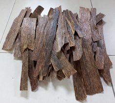 several pieces of wood sitting on top of a white tile floor next to each other