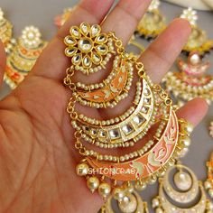 5 pair of assorted golden-toned Traditional Handmade Meenakari Earring for Women with hanging pearls. Size & Other Details Material  : Alloy, Pearl, Meena work Attire :  Lehenga Choli, Salwar Suit, Kurti, Saree, Flared Dress Pieces : 5pc Assorted design will come depending on the stock available. Gold Meenakari Dangle Hoop Earrings, Kundan Meenakari Hoop Earrings As A Gift, Gold Chandbalis With Meenakari Detailing, Gold Chandbalis With Meenakari, Meenakari Metal Danglers As Gift, Gift Meenakari Danglers In Metal, Gift Meenakari Metal Danglers, Metal Danglers With Meenakari For Gift, Metal Meenakari Earrings For Festivals