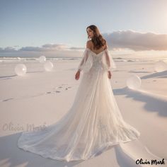 a woman is standing in the snow wearing a wedding dress with long sleeves and an open back