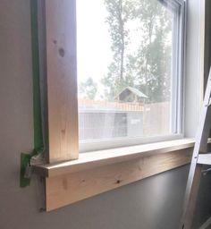 a ladder is next to a window in a house