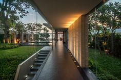 a long hallway with stairs leading up to the top floor and an open air swimming pool