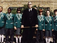 a group of young men standing next to each other in front of a brick building