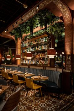 the interior of a restaurant with many tables and chairs