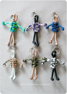 six keychains with different designs and colors on them, all in the same shape