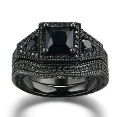 a black diamond engagement ring set with two rows of diamonds on the sides and an intricate band