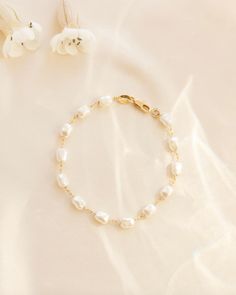 Pearl bracelet, Dainty pearl bracelet, Pearl jewelry, Delicate bracelet, Wedding jewelry, Bridal jewelry, Elegant bracelet, Gift for her --- Elevate your outfit with the Lily Bracelet. This chunky pearl bracelet is a must-have addition to any fun and chic outfit. With an extender for easy wearing, it is one of our favorites. Stacked here with our Chloe Bracelet, Camilla Bracelet, and our Devon Bracelet. The sister to this is our Lily Necklace! Details: - Gold Filled - 2" extender Classic Pearl Charm Chain Bracelet For Wedding, Elegant Pearl Charm Chain Bracelet For Wedding, Wedding Gold Bracelet With Pearl Drop, Wedding Gold Pearl Bracelet With Pearl Drop, Wedding Gold Pearl Drop Bracelet, Pearl White Beaded Bracelets With Pearl Chain For Anniversary, Dainty Pearl Chain Bracelet For Anniversary, Pearl Chain Bracelet For Wedding, Dainty Pearl Bracelet For Anniversary