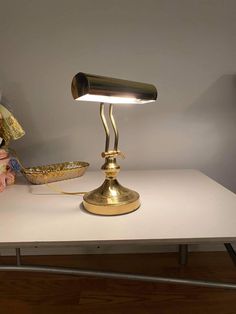 a desk lamp sitting on top of a table next to a bowl and teddy bear