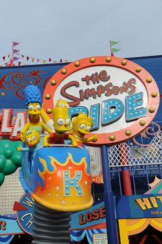 the simpsons ride at an amusement park is brightly colored and has characters on it's sides