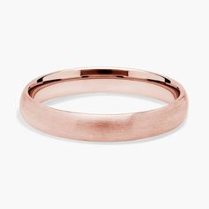 a rose gold wedding ring with a thin band on the outside, and a slight edge