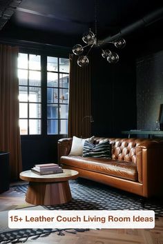 a leather couch sitting in front of a window next to a table with books on it