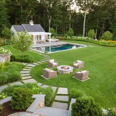 a backyard with a fire pit surrounded by lawn furniture