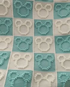 a crocheted blanket with hearts on it