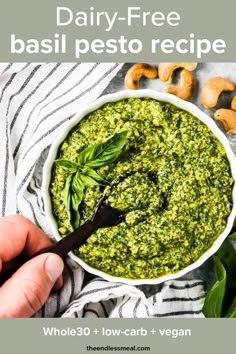 a bowl filled with basil pest and cashews