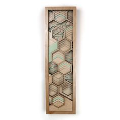 a wooden wall hanging with an abstract design on the front and back side, made out of wood