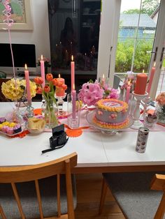 a table is set with flowers and candles for a birthday party or bridal celebration