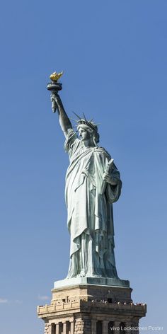 the statue of liberty in new york city, ny is shown against a blue sky