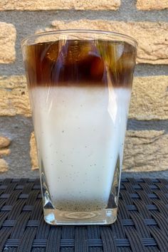 vanilla latte with homemade vanilla syrup recipe in a glass on a wicker table