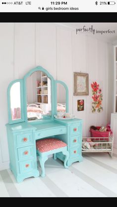 a doll house bedroom with a desk and mirror on the wall next to a bed